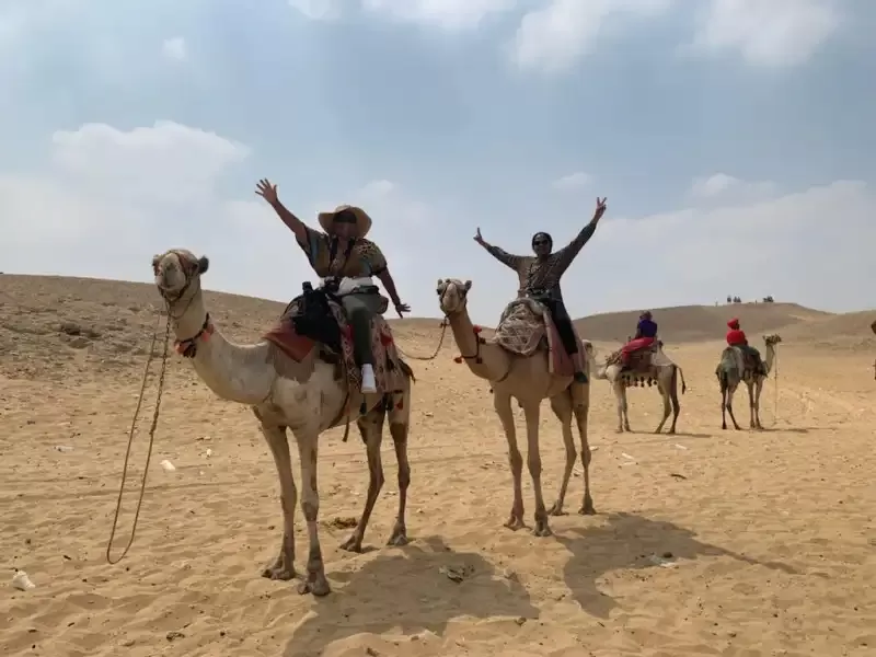 Camel ride at Giza Pyramids during a Cairo day tour with panoramic views